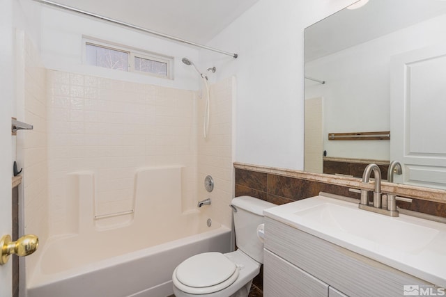 full bathroom featuring shower / washtub combination, toilet, tile walls, and vanity