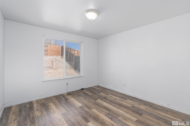 spare room featuring dark hardwood / wood-style floors