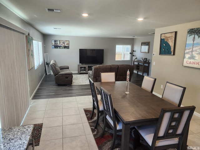 dining room with light tile patterned flooring and a healthy amount of sunlight