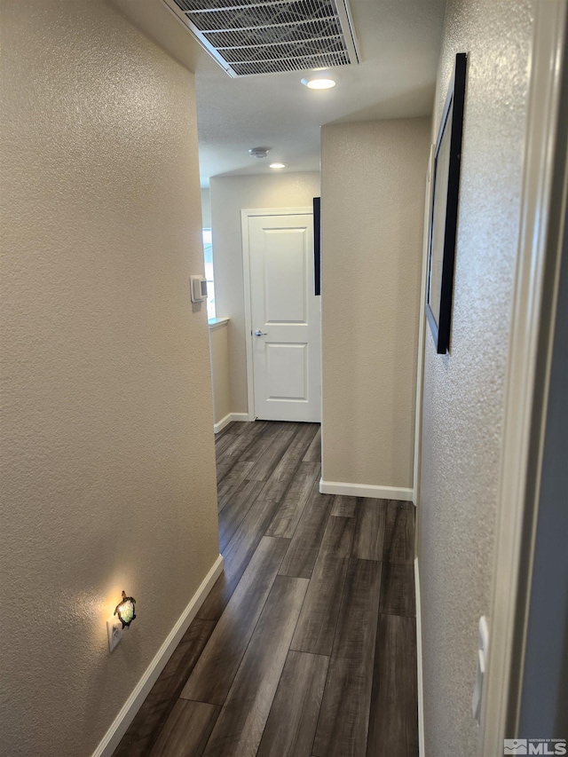 hallway with dark hardwood / wood-style floors