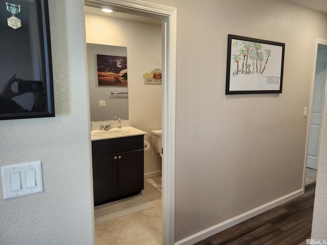 bathroom featuring vanity, hardwood / wood-style floors, and toilet