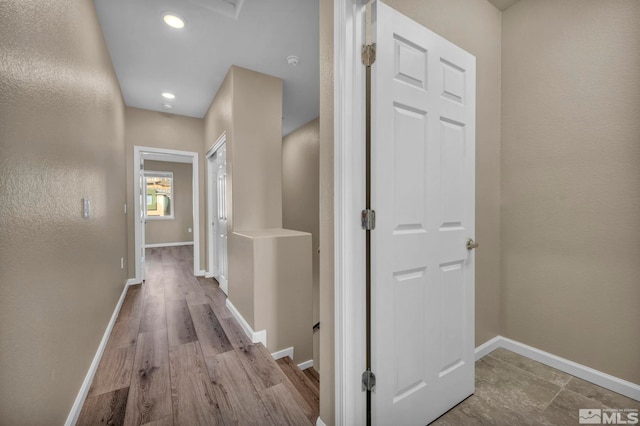 hallway with light hardwood / wood-style floors