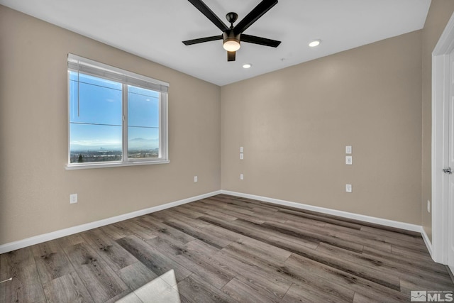 unfurnished room featuring ceiling fan and light wood-type flooring