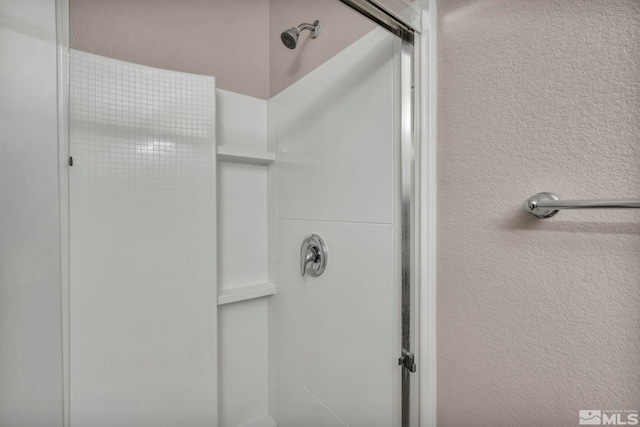 bathroom with a shower with shower door