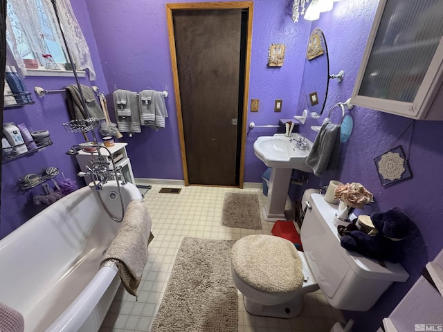 bathroom with toilet and a tub to relax in