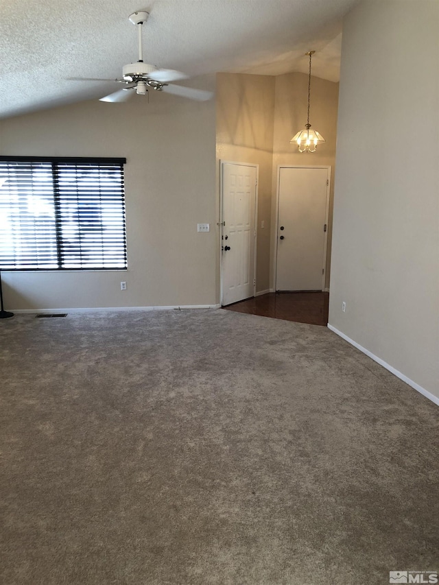 carpeted empty room featuring ceiling fan, high vaulted ceiling, and a textured ceiling