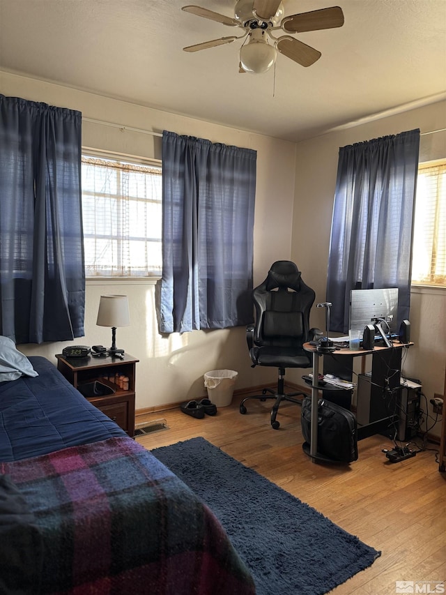 bedroom with hardwood / wood-style flooring and ceiling fan