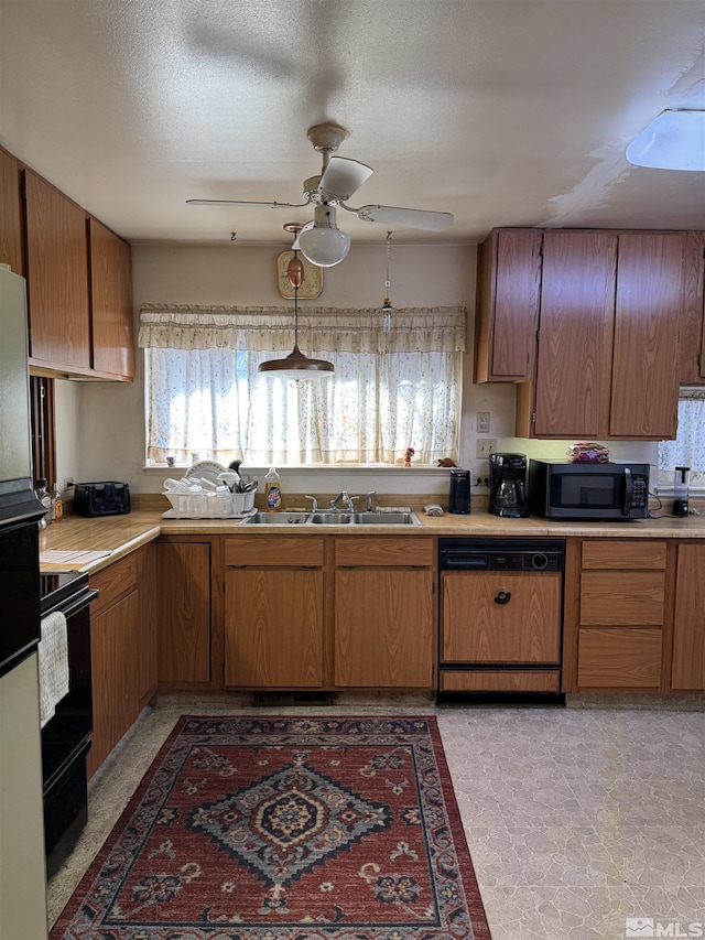 kitchen featuring sink, paneled dishwasher, ceiling fan, hanging light fixtures, and black range with electric stovetop