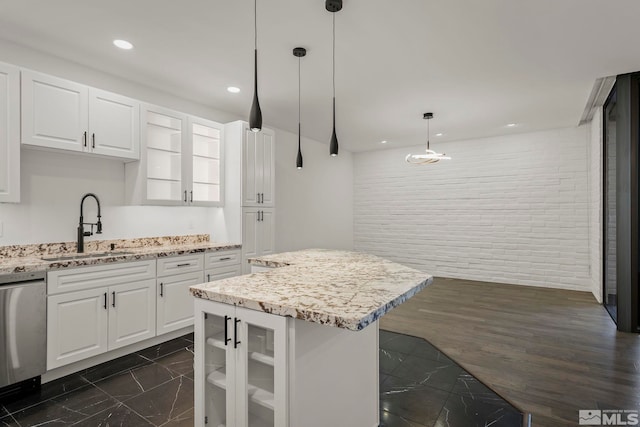 kitchen featuring hanging light fixtures, dishwasher, sink, and white cabinets