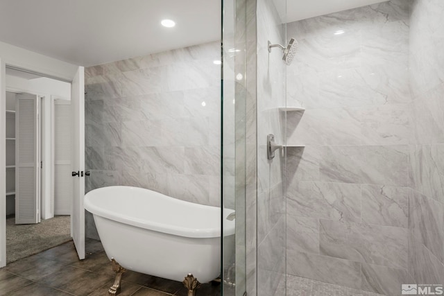 bathroom with tile walls, tile patterned floors, and independent shower and bath