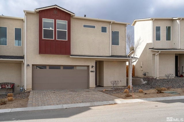 multi unit property featuring a garage