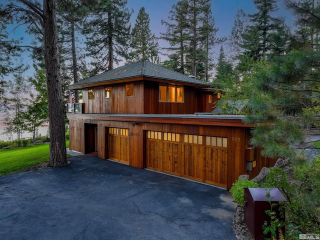 view of garage at dusk