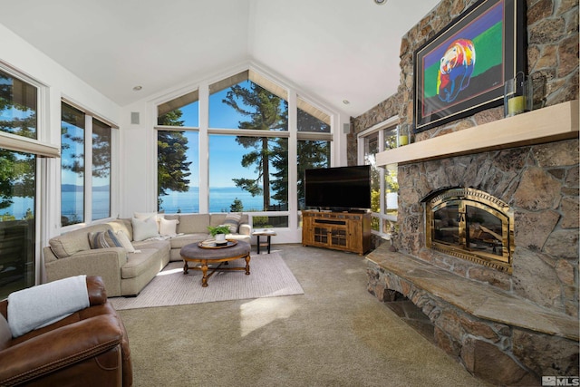 living room featuring carpet flooring, a stone fireplace, and high vaulted ceiling