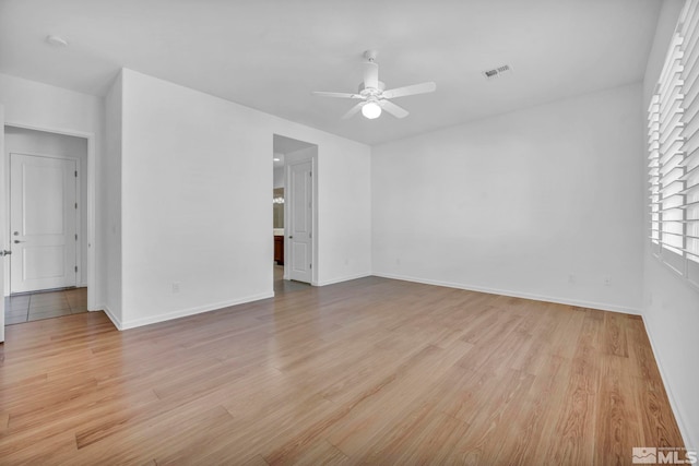 spare room featuring ceiling fan and light hardwood / wood-style floors