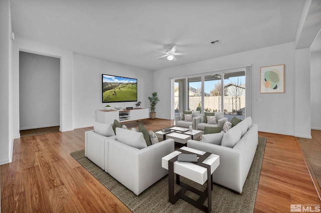 living room featuring ceiling fan and light hardwood / wood-style flooring