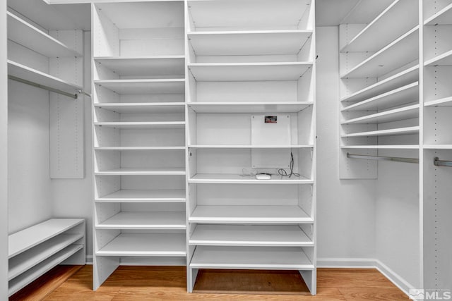 spacious closet featuring hardwood / wood-style floors