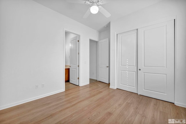 unfurnished bedroom featuring a closet, connected bathroom, ceiling fan, and light hardwood / wood-style flooring