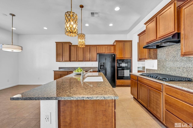 kitchen featuring sink, a kitchen island with sink, extractor fan, black appliances, and decorative light fixtures