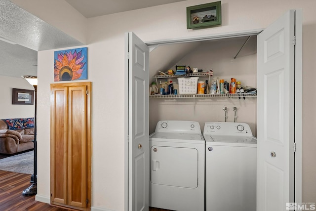 laundry room with separate washer and dryer and dark hardwood / wood-style flooring