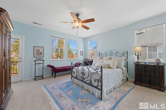 bedroom featuring access to outside, light colored carpet, and ceiling fan