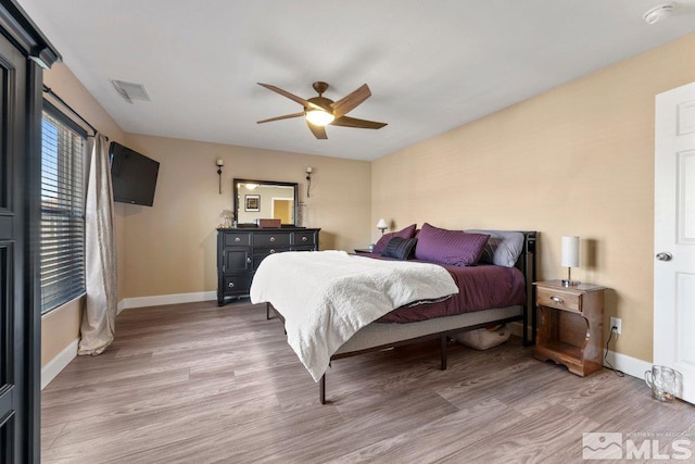 bedroom featuring hardwood / wood-style flooring and ceiling fan