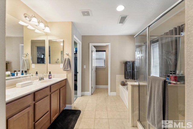 bathroom with vanity, tile patterned floors, and plus walk in shower