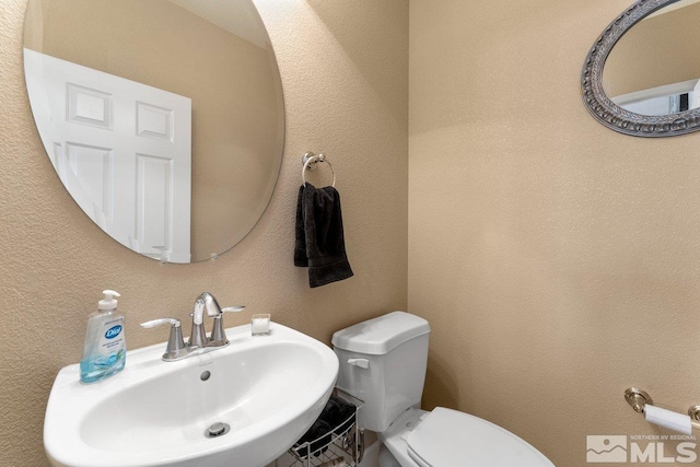 bathroom featuring toilet and sink