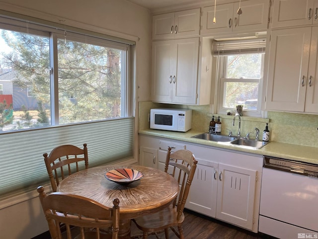 kitchen featuring sink, white appliances, dark wood-type flooring, white cabinetry, and decorative backsplash