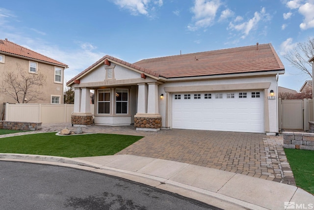 view of front of property with a garage and a front lawn