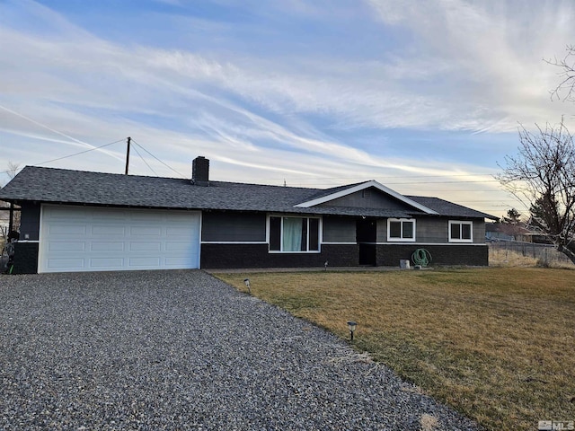 single story home featuring a yard and a garage