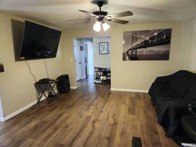 living room with hardwood / wood-style floors and ceiling fan