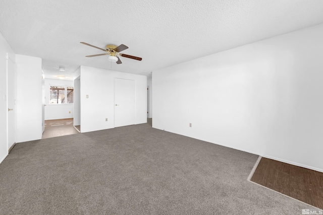 interior space with ceiling fan, carpet floors, a textured ceiling, and ensuite bath