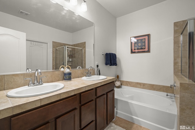 bathroom featuring vanity, shower with separate bathtub, and tile patterned floors