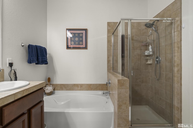 bathroom featuring vanity and shower with separate bathtub