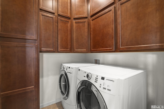 laundry area with cabinets and washer and clothes dryer