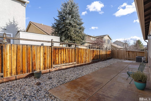 view of yard featuring central AC unit and a patio area