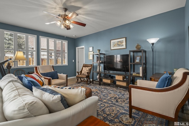 carpeted living room with ceiling fan