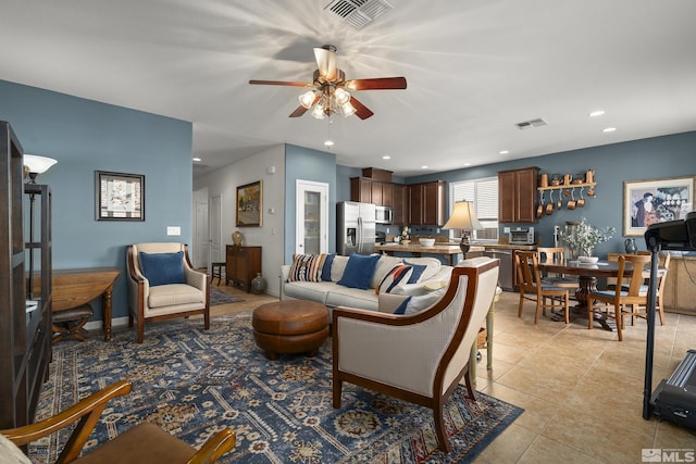 living room featuring light tile patterned floors and ceiling fan