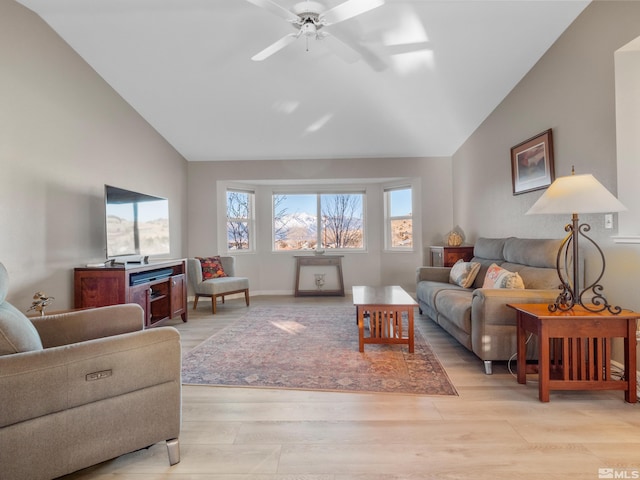 living room with vaulted ceiling, light hardwood / wood-style floors, and ceiling fan