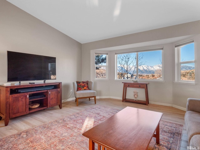 living room with vaulted ceiling and light wood-type flooring