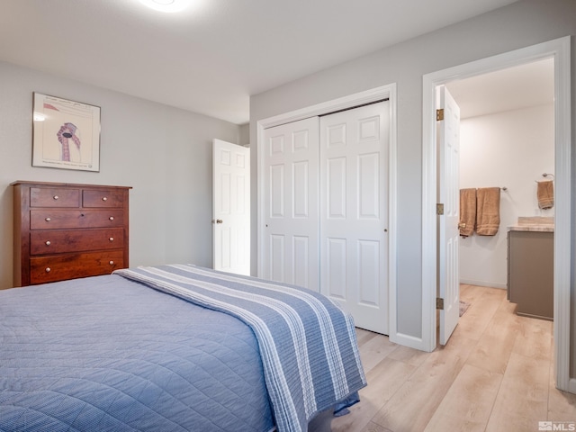 bedroom featuring a closet and light wood-type flooring