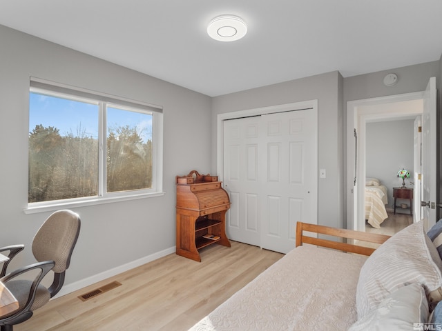 bedroom featuring light hardwood / wood-style floors and a closet