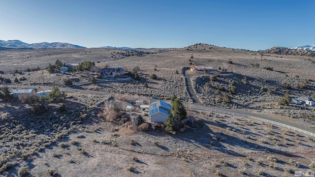 birds eye view of property featuring a mountain view