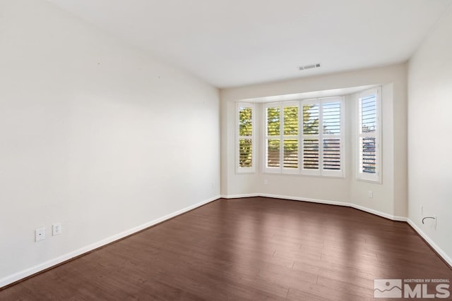 empty room featuring dark hardwood / wood-style floors