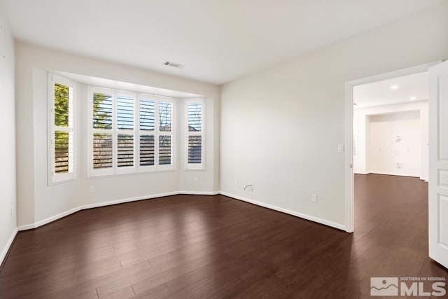 empty room featuring dark hardwood / wood-style floors