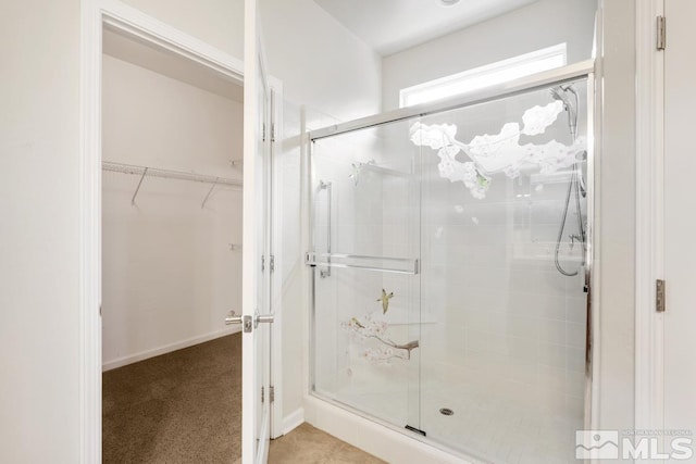 bathroom featuring a shower with shower door