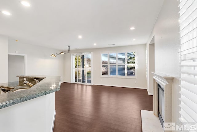 living room featuring dark hardwood / wood-style floors and sink