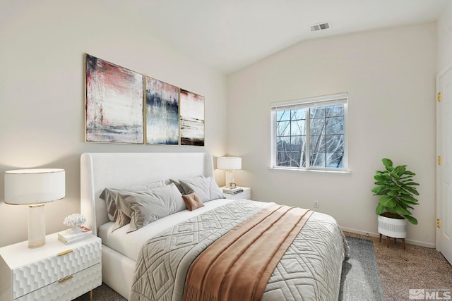 bedroom with vaulted ceiling and carpet