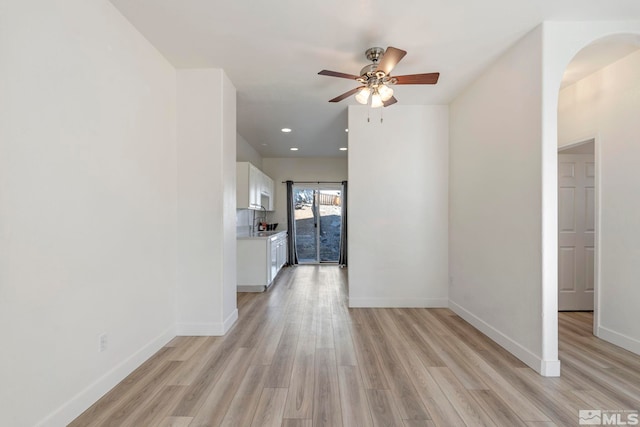 hallway with light hardwood / wood-style floors