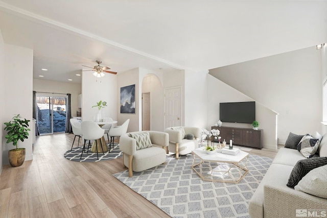 living room featuring ceiling fan and light hardwood / wood-style floors